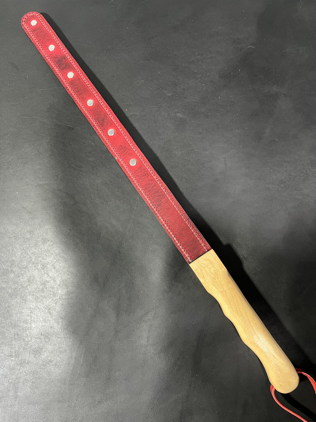 Strap: Red Latigo strap with Birdseye maple handle and rivets